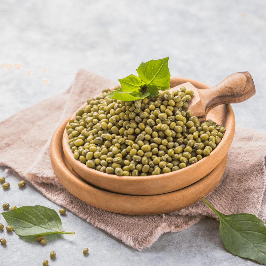 Whole green mungbeans in a wooden bowl and scoop
